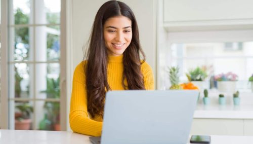 website management smiling-min girl smiling at the computer happy with website management